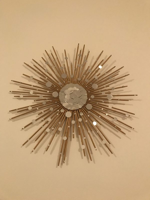 A decorative stick of wood or metal for collecting pieces on the wall